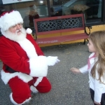 Van Otis professional Santa entertaining children at a holiday celebration on ImSanta